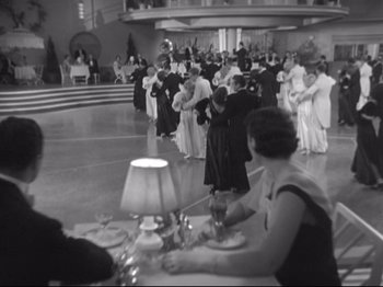 Movie still from “The Gay Divorcee” (1934), directed by Mark Sandrich – A black and white photo of people dancing at a party; Extreme Wide shot, High angle