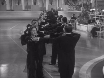 Movie still from “The Gay Divorcee” (1934), directed by Mark Sandrich – Black and white photograph of a line of people in formal wear; Wide shot, High angle