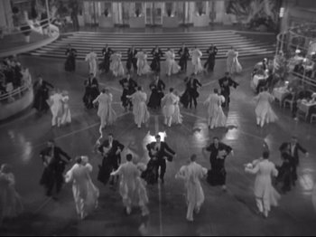 Movie still from “The Gay Divorcee” (1934), directed by Mark Sandrich – An aerial view of a group of people dancing in a circle; Extreme Wide shot, High angle