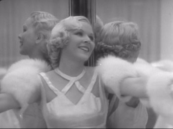 Movie still from “The Gay Divorcee” (1934), directed by Mark Sandrich – A black - and - white photo of a woman in front of a mirror; Medium shot, Low angle