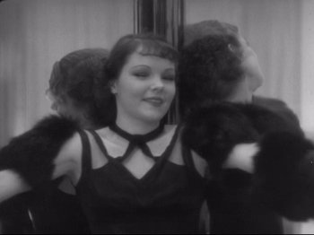 Movie still from “The Gay Divorcee” (1934), directed by Mark Sandrich – A black and white photo of a woman in a black dress; Medium shot, Low angle