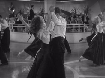 Movie still from “The Gay Divorcee” (1934), directed by Mark Sandrich – A black and white photo of a group of people dancing; Wide shot, Low angle