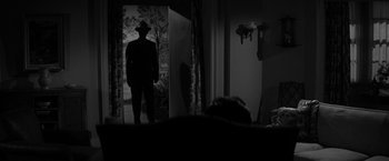 Movie still from “The Gazebo” (1959), directed by George Marshall – A man standing in front of an open door in a room; Wide shot, Over the shoulder angle