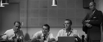 Movie still from “The Gazebo” (1959), directed by George Marshall – A black and white photo of two men sitting in front of a computer; Medium shot, Low angle