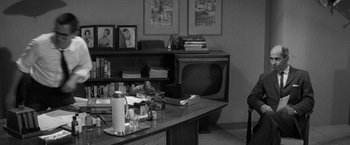 Movie still from “The Gazebo” (1959), directed by George Marshall – An old tv sitting on top of a desk; Wide shot, High angle