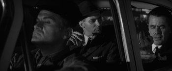 Movie still from “The Gazebo” (1959), directed by George Marshall – A black and white photo of a man in a car; Close Up shot, Low angle