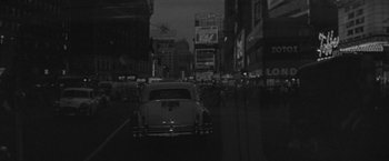 Movie still from “The Gazebo” (1959), directed by George Marshall – A car is parked on the side of the street; Extreme Wide shot, High angle