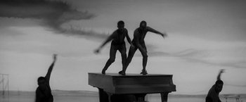 Movie still from “The Gazebo” (1959), directed by George Marshall – A couple of men standing on top of a wooden platform; Wide shot, High angle