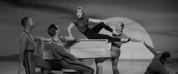 Movie still from “The Gazebo” (1959), directed by George Marshall – A black - and - white photo of a woman and two men; Medium shot, High angle