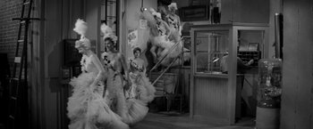 Movie still from “The Gazebo” (1959), directed by George Marshall – A group of women dressed in fancy outfits; Wide shot, Low angle