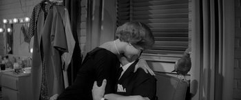 Movie still from “The Gazebo” (1959), directed by George Marshall – An old photo of a man and a woman hugging; Medium shot, High angle