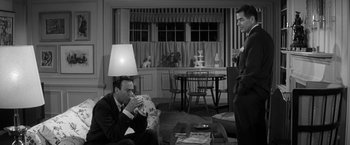 Movie still from “The Gazebo” (1959), directed by George Marshall – Two men in a living room drinking wine; Medium shot, High angle