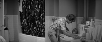 Movie still from “The Gazebo” (1959), directed by George Marshall – A woman is standing in front of a bathroom sink; Wide shot, High angle