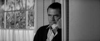 Movie still from “The Gazebo” (1959), directed by George Marshall – A black and white photo of a man talking on a phone; Close Up shot, Low angle