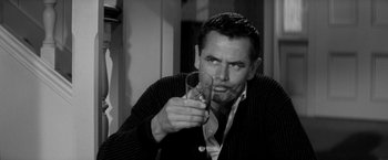 Movie still from “The Gazebo” (1959), directed by George Marshall – A black and white photo of a man holding a wine glass; Close Up shot, Over the shoulder angle
