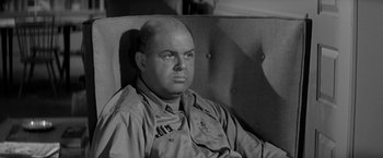 Movie still from “The Gazebo” (1959), directed by George Marshall – An old photo of a man sitting in a chair; Close Up shot, High angle