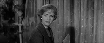Movie still from “The Gazebo” (1959), directed by George Marshall – An old photo of a woman in a black suit; Close Up shot, Over the shoulder angle