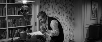 Movie still from “The Gazebo” (1959), directed by George Marshall – A black and white photo of a man playing a keyboard; Medium shot, High angle