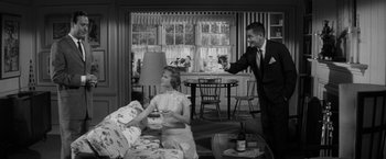Movie still from “The Gazebo” (1959), directed by George Marshall – A man and a woman are drinking wine; Wide shot, Low angle