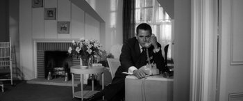 Movie still from “The Gazebo” (1959), directed by George Marshall – A black and white photo of a man on the phone; Medium shot, Low angle