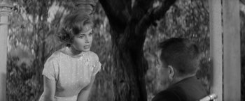 Movie still from “The Gazebo” (1959), directed by George Marshall – A man and a woman are talking to each other; Close Up shot, Over the shoulder angle