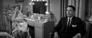 Movie still from “The Gazebo” (1959), directed by George Marshall – A man sitting in front of a mirror in a dressing room; Medium shot, High angle