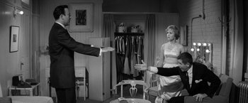 Movie still from “The Gazebo” (1959), directed by George Marshall – A man and a woman are in a room; Medium shot, Over the shoulder angle