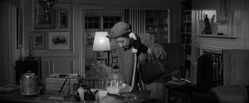 Movie still from “The Gazebo” (1959), directed by George Marshall – An older woman talking on a phone in a living room; Medium shot, High angle