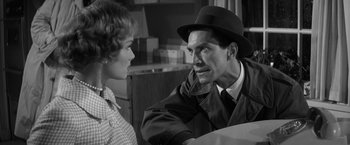 Movie still from “The Gazebo” (1959), directed by George Marshall – A man and a woman talking to each other in a room; Medium shot, Over the shoulder angle