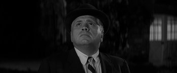 Movie still from “The Gazebo” (1959), directed by George Marshall – An old photo of a man in a suit and hat; Close Up shot, Low angle