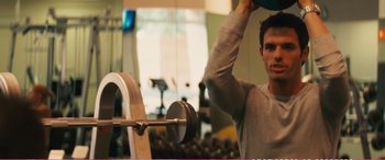 Movie still from “The Girlfriend Experience” (2009), directed by Steven Soderbergh – A man is lifting a barbell in a gym; Medium shot, Low angle