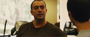 Movie still from “The Girlfriend Experience” (2009), directed by Steven Soderbergh – A person wearing a brown t - shirt; Close Up shot, Over the shoulder angle