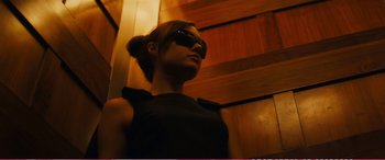 Movie still from “The Girlfriend Experience” (2009), directed by Steven Soderbergh – A woman wearing sunglasses looking up at the ceiling; Medium shot, Low angle