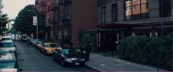 Movie still from “The Girlfriend Experience” (2009), directed by Steven Soderbergh – A car parked on the side of the road near a building; Extreme Wide shot, High angle