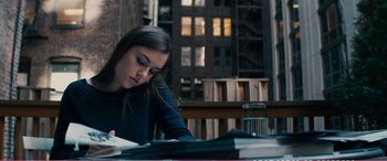 Movie still from “The Girlfriend Experience” (2009), directed by Steven Soderbergh – A woman sitting at a table writing on a piece of paper; Medium shot, Over the shoulder angle