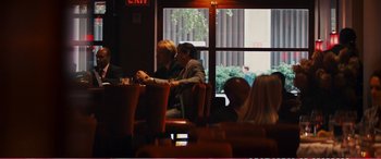 Movie still from “The Girlfriend Experience” (2009), directed by Steven Soderbergh – A group of people sitting at a table in front of a window; Wide shot, Over the shoulder angle