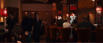Movie still from “The Girlfriend Experience” (2009), directed by Steven Soderbergh – A group of people standing around a table in a restaurant; Wide shot, Over the shoulder angle