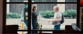 Movie still from “The Girlfriend Experience” (2009), directed by Steven Soderbergh – A woman standing in front of a man in front of a bus; Medium shot, Over the shoulder angle