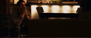 Movie still from “The Girlfriend Experience” (2009), directed by Steven Soderbergh – A person sitting at a table in a room; Medium shot, Over the shoulder angle
