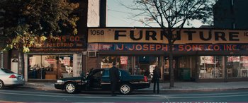 Movie still from “The Girlfriend Experience” (2009), directed by Steven Soderbergh – A man standing in front of a black car; Wide shot, High angle