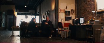 Movie still from “The Girlfriend Experience” (2009), directed by Steven Soderbergh – A man and a woman sitting on couches in a room; Wide shot, Over the shoulder angle