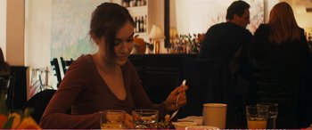 Movie still from “The Girlfriend Experience” (2009), directed by Steven Soderbergh – A woman sitting at a table with a spoon in her hand; Medium shot, Over the shoulder angle