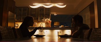 Movie still from “The Girlfriend Experience” (2009), directed by Steven Soderbergh – A person sitting at a table with a glass of wine; Medium shot, Over the shoulder angle