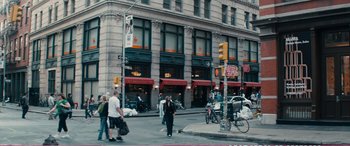 Movie still from “The Girlfriend Experience” (2009), directed by Steven Soderbergh – A group of people crossing a street in front of a building; Extreme Wide shot, High angle