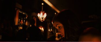 Movie still from “The Girlfriend Experience” (2009), directed by Steven Soderbergh – A woman is looking down at her face in a dark room; Close Up shot, Over the shoulder angle