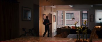 Movie still from “The Girlfriend Experience” (2009), directed by Steven Soderbergh – A man in a living room holding a guitar; Wide shot, Over the shoulder angle
