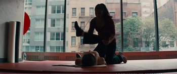 Movie still from “The Girlfriend Experience” (2009), directed by Steven Soderbergh – A woman sitting on the ground with her feet on the ground; Wide shot, High angle