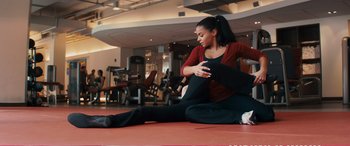 Movie still from “The Girlfriend Experience” (2009), directed by Steven Soderbergh – A woman sitting on the ground stretching her legs; Wide shot, Low angle