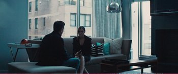 Movie still from “The Girlfriend Experience” (2009), directed by Steven Soderbergh – A man and a woman are sitting on a couch; Medium shot, Over the shoulder angle