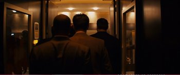 Movie still from “The Girlfriend Experience” (2009), directed by Steven Soderbergh – A group of men in suits walking down a hall way; Medium shot, Low angle
